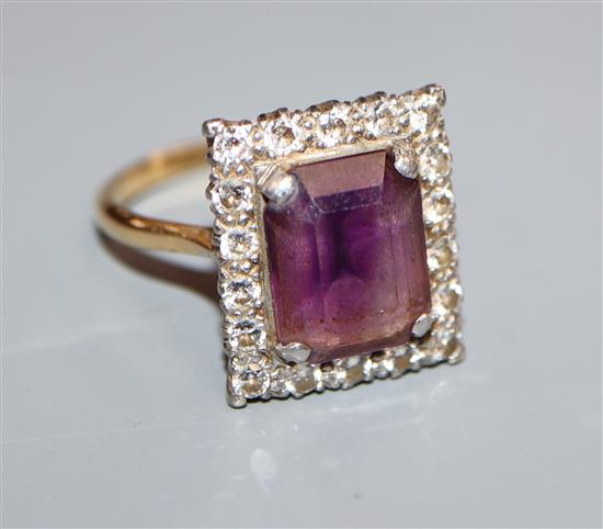 An 18ct and plat, amethyst and diamond set square cluster ring, size U.